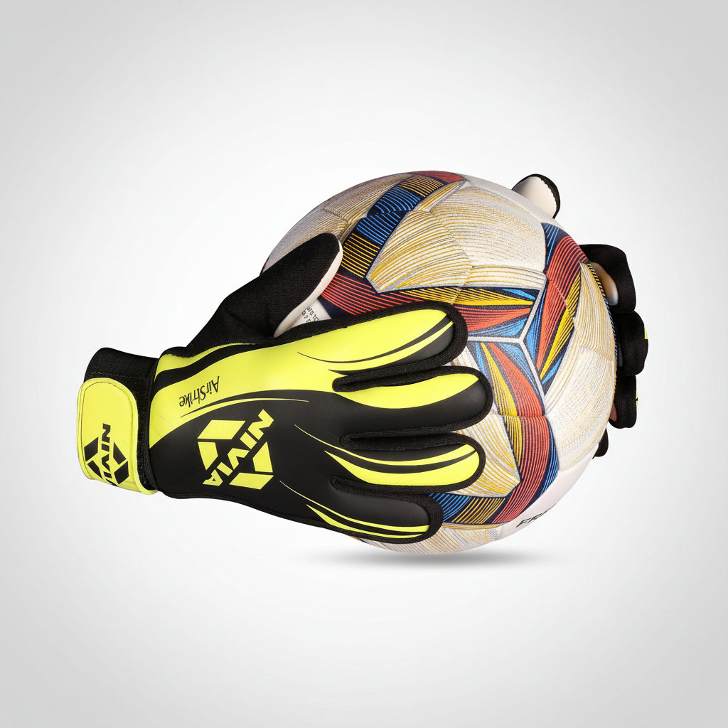 A pair of goalkeeper gloves in black and neon yellow holding a white soccer ball with a multicolor geometric pattern, set against a plain white background.