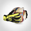 A pair of goalkeeper gloves in black and neon yellow holding a white soccer ball with a multicolor geometric pattern, set against a plain white background.